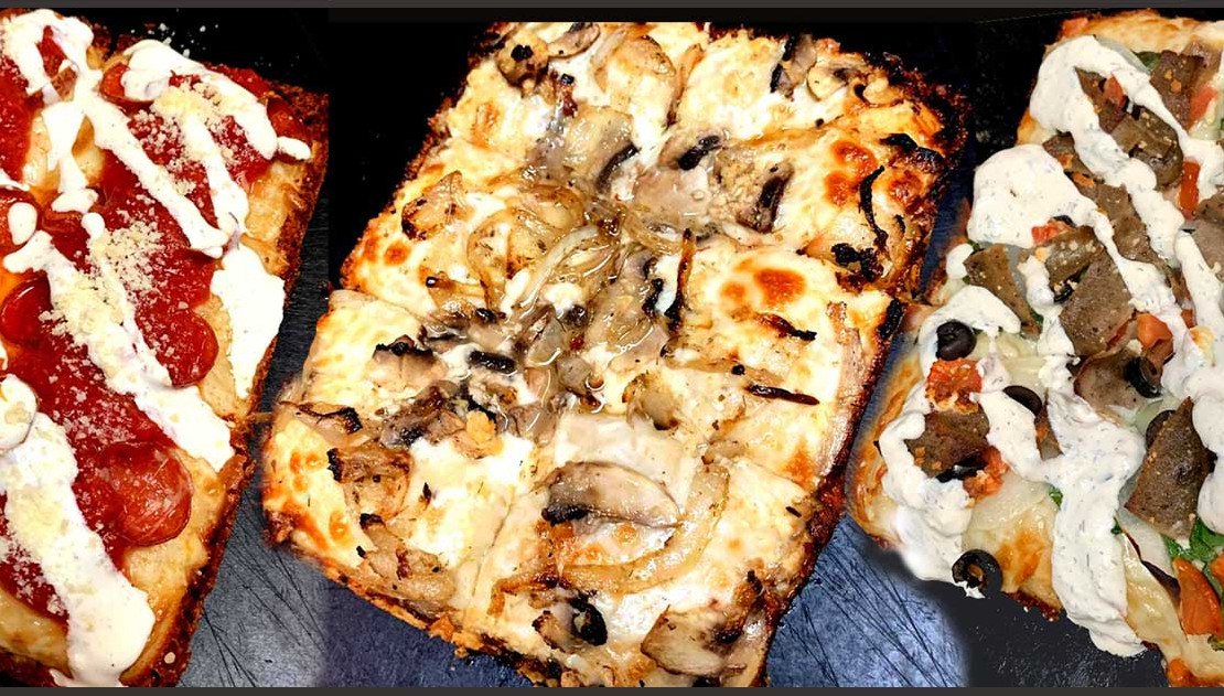 Detroit-style pizza with golden cheese and crispy edges from Holiday Pizza