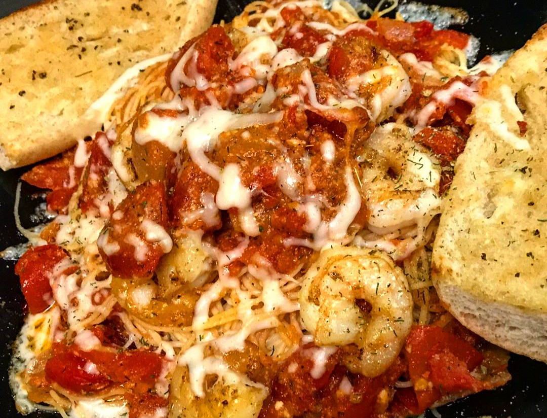 Fresh Greek salad topped with grilled chicken, feta, and house-made dressing