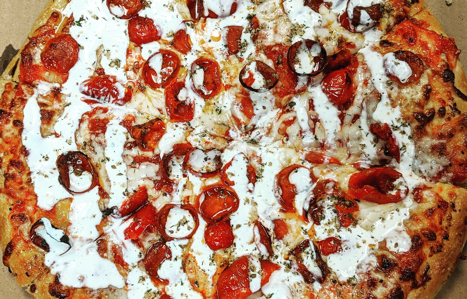 Spread of Holiday Pizza dishes including pizza, salads, and sides on a dining table